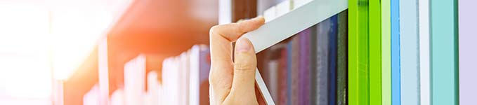 Hand pulling iPad off shelf Hand pulling iPad off shelf