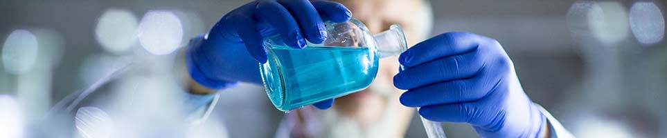 Branched alcohols scientist pouring blue liquid