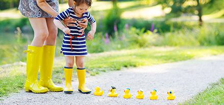 Plasticizers child with rubber ducks photo