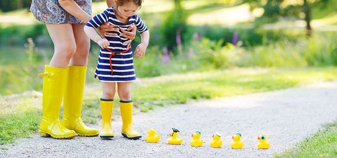 Plasticizers child with rubber ducks photo