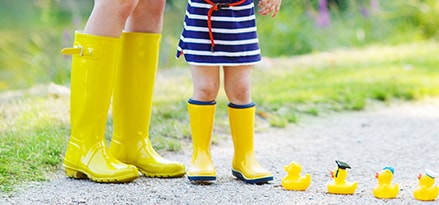 Mom and Child with rubber ducks on pathway
