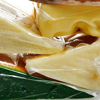 Stack of cheeses in shrink wrap