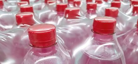 Bottles covered with shrink packaging red cap