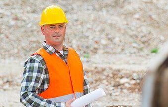 construction worker with hard hat and plans