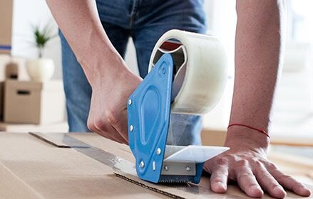 Person taping box with tape