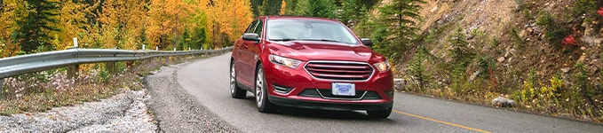 Red Car taking turn on street