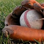 Baseball glove and ball in field