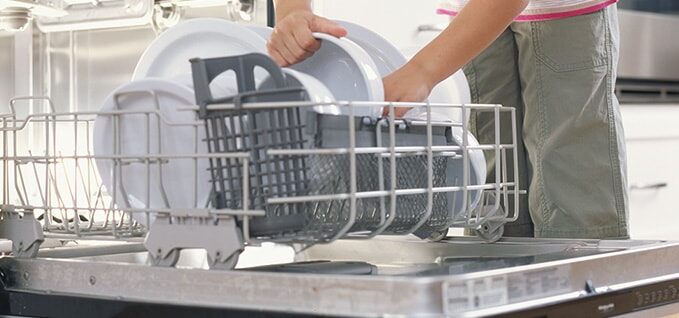 Child loading dishwasher