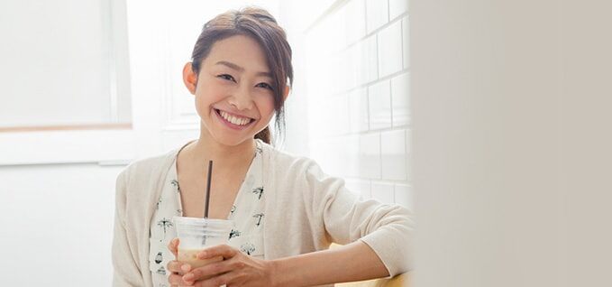 Girl with iced coffee in plastic cup