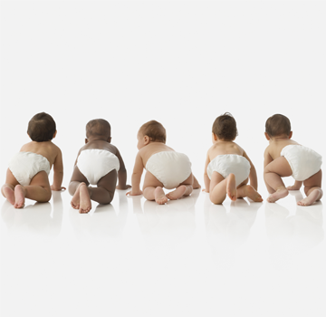 Five crawling babies in diapers from behind.