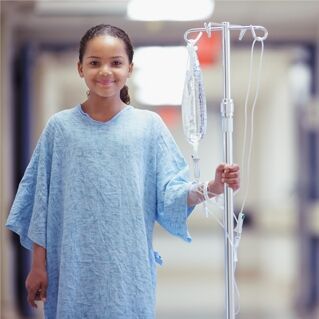 Young girl in hospital with IV bag
